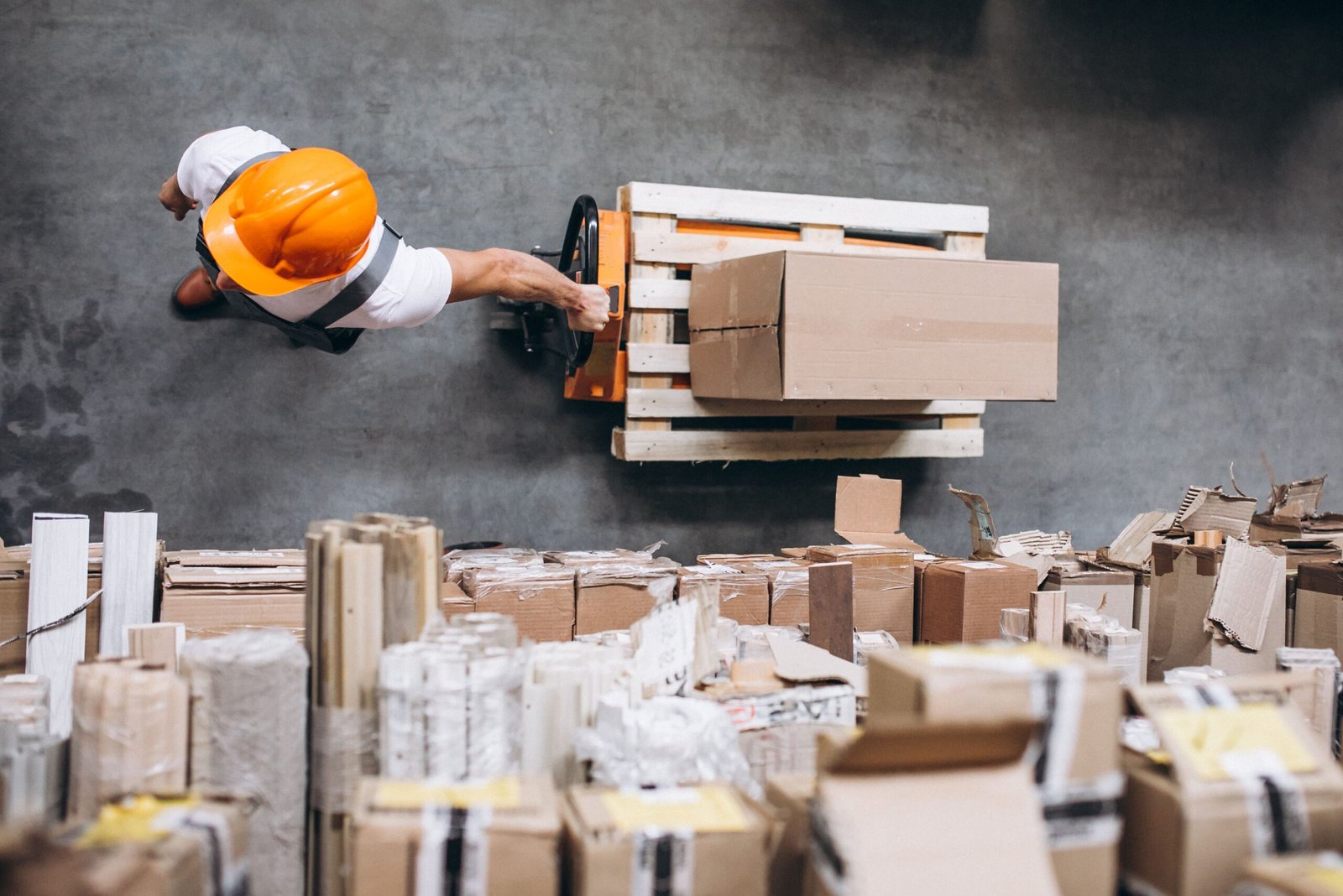 young-man-working-warehouse-with-boxes-min